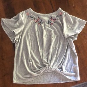 Gray top with floral stitch.